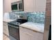 Modern kitchen featuring granite countertops, stainless steel appliances, and stylish backsplash at 2881 Pope St, North Port, FL 34287