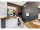 The main bathroom features a vanity with granite counters and gold hardware, hexagonal floors, and a round accent mirror at 307B 63Rd St, Holmes Beach, FL 34217