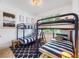 Charming bedroom featuring bunk beds, nautical themed decor, and bright natural light at 307B 63Rd St, Holmes Beach, FL 34217