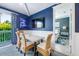 Dining area with access to balcony and view into bedroom, complete with wainscoting at 307B 63Rd St, Holmes Beach, FL 34217