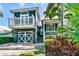 Charming two-story home with a delightful balcony, beautiful landscaping, and a well-kept lawn at 307B 63Rd St, Holmes Beach, FL 34217