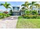 Inviting two-story home with lush landscaping, paved driveway, and a classic coastal aesthetic at 307B 63Rd St, Holmes Beach, FL 34217