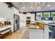 The bright kitchen features white cabinets, granite counters, and stainless steel appliances, open to the adjacent living area at 307B 63Rd St, Holmes Beach, FL 34217