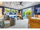 Cozy living room opens to balcony with light gray carpet and white beamed ceiling at 307B 63Rd St, Holmes Beach, FL 34217