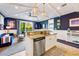 A bright, open floor plan includes a modern kitchen with granite countertops, seamlessly flowing into the living area at 307B 63Rd St, Holmes Beach, FL 34217