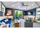 The airy living room showcases stylish seating, a glass coffee table, and views of the tropical landscape beyond the sliding doors at 307B 63Rd St, Holmes Beach, FL 34217