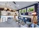 Charming living room with white wood ceiling, blue accent wall, and open flow to the kitchen at 307B 63Rd St, Holmes Beach, FL 34217