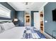 This main bedroom has access to the main bathroom and kitchen, with a view of the TV above a stylish side table at 307B 63Rd St, Holmes Beach, FL 34217