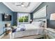 The main bedroom features a white wood frame bed, TV, and a ceiling fan, providing a comfortable and stylish retreat at 307B 63Rd St, Holmes Beach, FL 34217