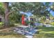 Enjoy a picnic by the pond with fountain at this outdoor grilling area, shaded by a large tree at 3269 Beneva Rd # 203, Sarasota, FL 34232