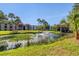 Scenic pond with a fountain, surrounded by lush greenery and palm trees at 3269 Beneva Rd # 203, Sarasota, FL 34232