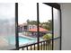 Balcony view overlooking the community pool and surrounding landscaped areas at 3269 Beneva Rd # 203, Sarasota, FL 34232