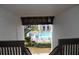 View from a condo stairwell overlooking a sparkling pool and well-manicured green space at 3269 Beneva Rd # 203, Sarasota, FL 34232