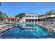 Large swimming pool with plenty of deck chairs surrounded by community buildings at 3269 Beneva Rd # 203, Sarasota, FL 34232