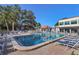Another view of this large swimming pool with plenty of deck chairs surrounded by community buildings at 3269 Beneva Rd # 203, Sarasota, FL 34232