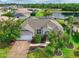 Stunning aerial view of a single-Gathering home boasting a manicured lawn, screened pool and scenic pond views at 3309 45Th E Ave, Bradenton, FL 34203