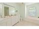 Bright bathroom with double vanity, soaking tub, and a glass-enclosed shower at 3309 45Th E Ave, Bradenton, FL 34203