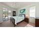 Serene bedroom featuring a bed, poolside view, and ample natural light at 3309 45Th E Ave, Bradenton, FL 34203