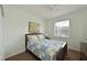 Cozy bedroom featuring a bed with quilt, ceiling fan, and natural light from the window at 3309 45Th E Ave, Bradenton, FL 34203