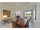 Bright dining room featuring a wood table set, modern art, and access to the outdoor area at 3309 45Th E Ave, Bradenton, FL 34203