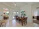 Well-lit dining room with tile flooring, wooden table, and access to the outdoor patio at 3309 45Th E Ave, Bradenton, FL 34203