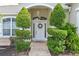 Inviting front entrance with decorative landscaping, a charming wreath, and a brick walkway at 3309 45Th E Ave, Bradenton, FL 34203