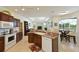 Open-concept kitchen with dark wood cabinetry, granite countertops, and seamless flow into the living area at 3309 45Th E Ave, Bradenton, FL 34203