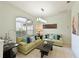 Cozy living room with comfortable sofas, decorative pillows, and a large window at 3309 45Th E Ave, Bradenton, FL 34203