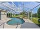 Beautiful screened-in pool and spa area with waterfall feature and serene backyard views at 3309 45Th E Ave, Bradenton, FL 34203