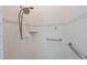 Accessible shower with grab bars, tile surround, and a handheld shower head at 3309 45Th E Ave, Bradenton, FL 34203