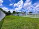 A spacious backyard is enclosed with a white picket fence, and well maintained lawn at 3600 Wisteria Pl, Punta Gorda, FL 33950