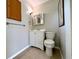 Cozy bathroom features a vanity sink, framed mirror, and a toilet at 3600 Wisteria Pl, Punta Gorda, FL 33950