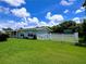 Charming home featuring a white picket fence, manicured lawn, and lush landscaping at 3600 Wisteria Pl, Punta Gorda, FL 33950