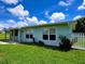 Charming single-story home with freshly cut grass and a white picket fence at 3600 Wisteria Pl, Punta Gorda, FL 33950