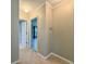 Neutral hallway showcases tile floors and interior doors to bedrooms and bathrooms at 3600 Wisteria Pl, Punta Gorda, FL 33950