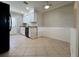 Open kitchen with white cabinets, black appliances, tile flooring, and access to the backyard at 3600 Wisteria Pl, Punta Gorda, FL 33950