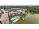 Complex aerial featuring the pool, pond, docks, and multiple buildings with parking at 3702 Lake Bayshore K-412 Dr # 412, Bradenton, FL 34205