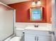 Cozy bathroom featuring a shower with sliding doors, single sink vanity and warm accent paint at 3702 Lake Bayshore K-412 Dr # 412, Bradenton, FL 34205