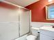 Cozy bathroom featuring a shower with sliding doors, single sink vanity and warm accent paint at 3702 Lake Bayshore K-412 Dr # 412, Bradenton, FL 34205