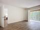 Bright bedroom featuring wood-look floors and balcony access at 3702 Lake Bayshore K-412 Dr # 412, Bradenton, FL 34205