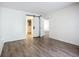 Light bedroom featuring wood-look floors and closet access at 3702 Lake Bayshore K-412 Dr # 412, Bradenton, FL 34205