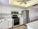 Updated kitchen with white cabinets, subway tile backsplash, and stainless steel appliances at 3702 Lake Bayshore K-412 Dr # 412, Bradenton, FL 34205