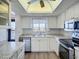 Bright kitchen features white cabinets, stainless steel appliances, and a window with a view of the complex at 3702 Lake Bayshore K-412 Dr # 412, Bradenton, FL 34205