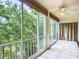 Screened lanai with tile floors and ceiling fan offers views of lush greenery at 3702 Lake Bayshore K-412 Dr # 412, Bradenton, FL 34205