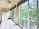 Tiled lanai with ceiling fan provides a serene view of the surrounding trees at 3702 Lake Bayshore K-412 Dr # 412, Bradenton, FL 34205