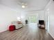 Bright living room with modern flooring and a sliding glass door to the balcony at 3702 Lake Bayshore K-412 Dr # 412, Bradenton, FL 34205