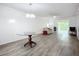 Open concept living room featuring light, neutral paint, modern flooring, and access to the lanai at 3702 Lake Bayshore K-412 Dr # 412, Bradenton, FL 34205