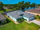 Aerial view of house with manicured lawn and lake view at 3718 61St E Dr, Bradenton, FL 34203