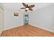 A cozy bedroom with neutral walls, wood-look floors, and a ceiling fan at 3718 61St E Dr, Bradenton, FL 34203