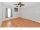 Bright bedroom features light-colored walls, a ceiling fan, and wood-look floors at 3718 61St E Dr, Bradenton, FL 34203